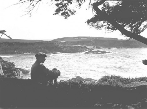 Dr. Alister MacKenzie sitting under tree, with the 16th hole view, Nov 1928